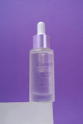 CureX serum bottle with dropper on a purple background