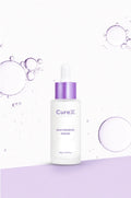 CureX niacinamide serum bottle with bubbles on a light purple background