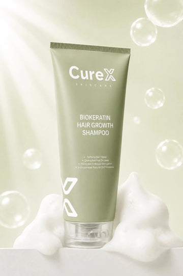Curex Biokeratin Hair Growth Shampoo tube with bubbles on a light green background
