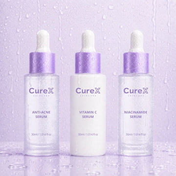 Three Curex skincare serum bottles on a light purple background